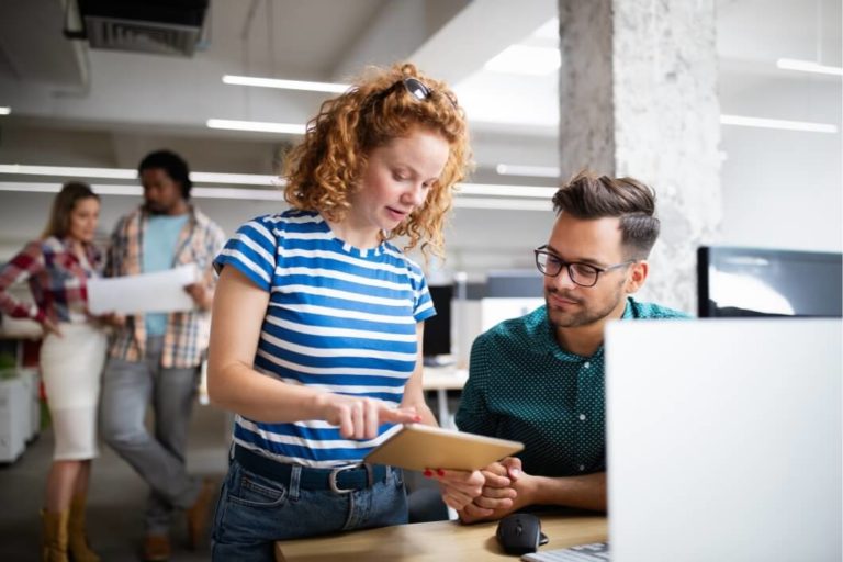 Digital marketing experts consulting about successful marketing strategies in front of a computer